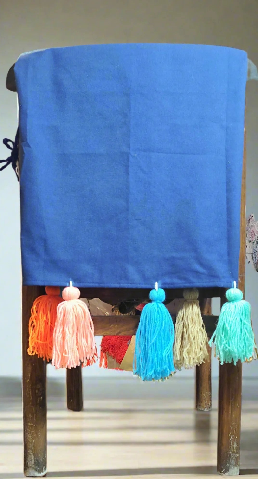 Navy blue chair cover with colourful tassel