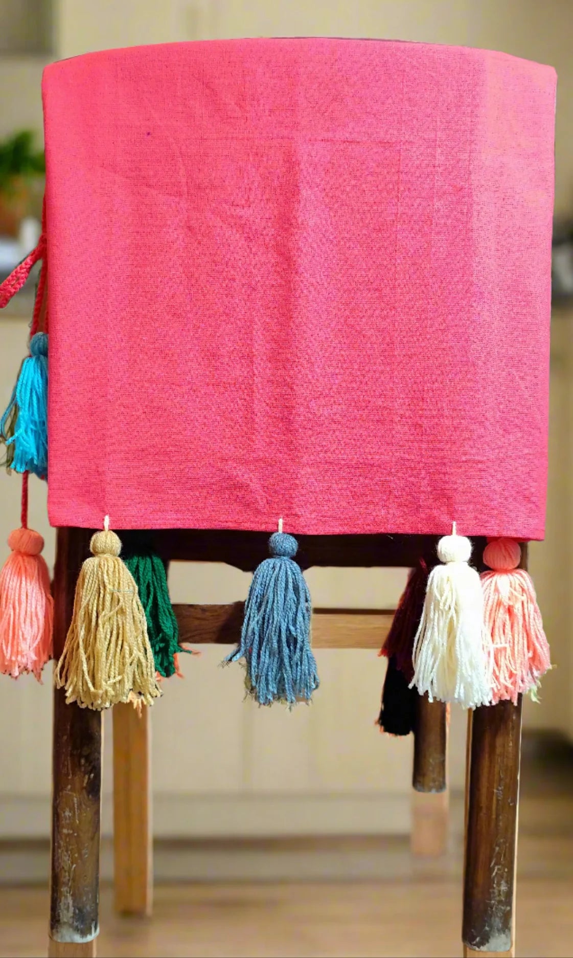Pink chair cover with colourful tassel