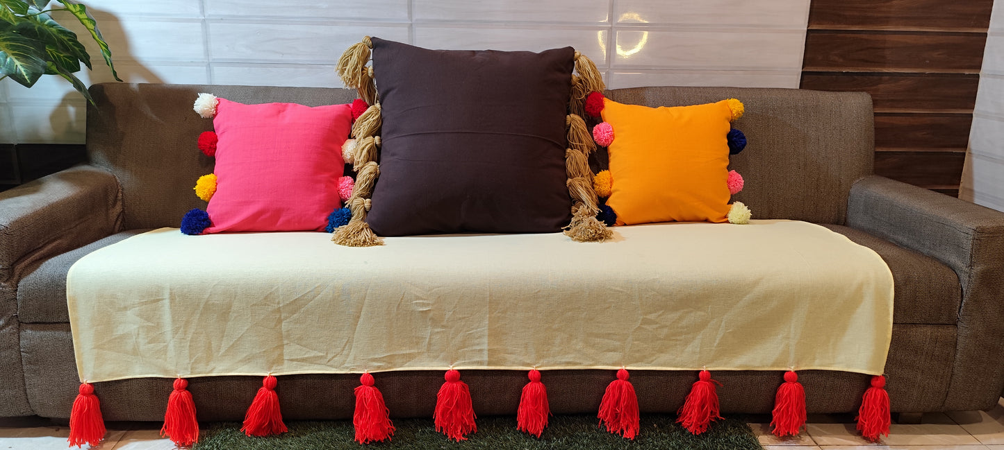 Lemon yellow sofa throw with red jumbo tassels