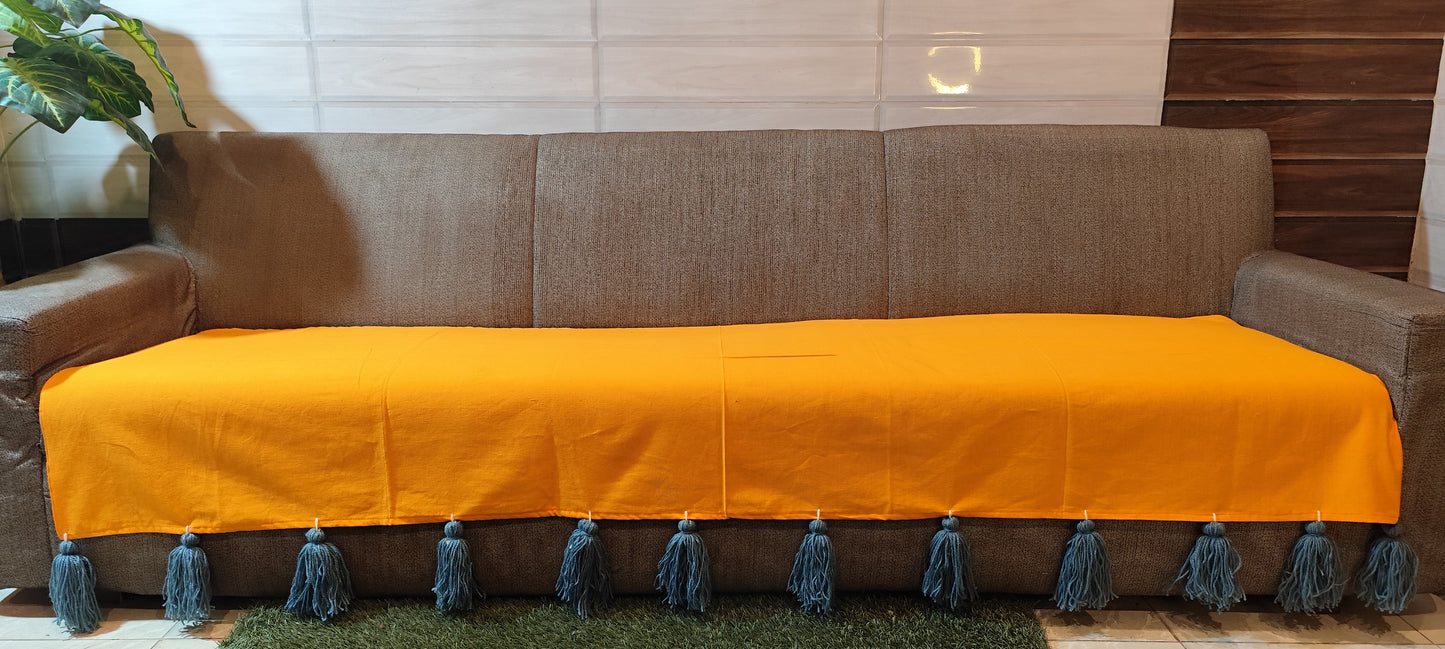 Mustard yellow sofa cover with grey jumbo tassels