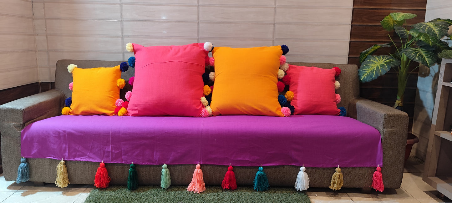 Purple sofa cover with jumbo rainbow tassel