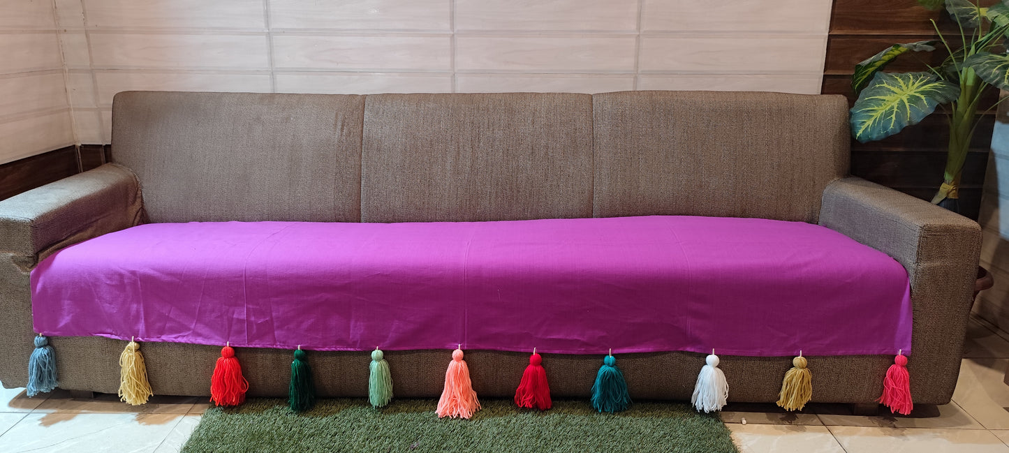 Purple sofa cover with jumbo rainbow tassel