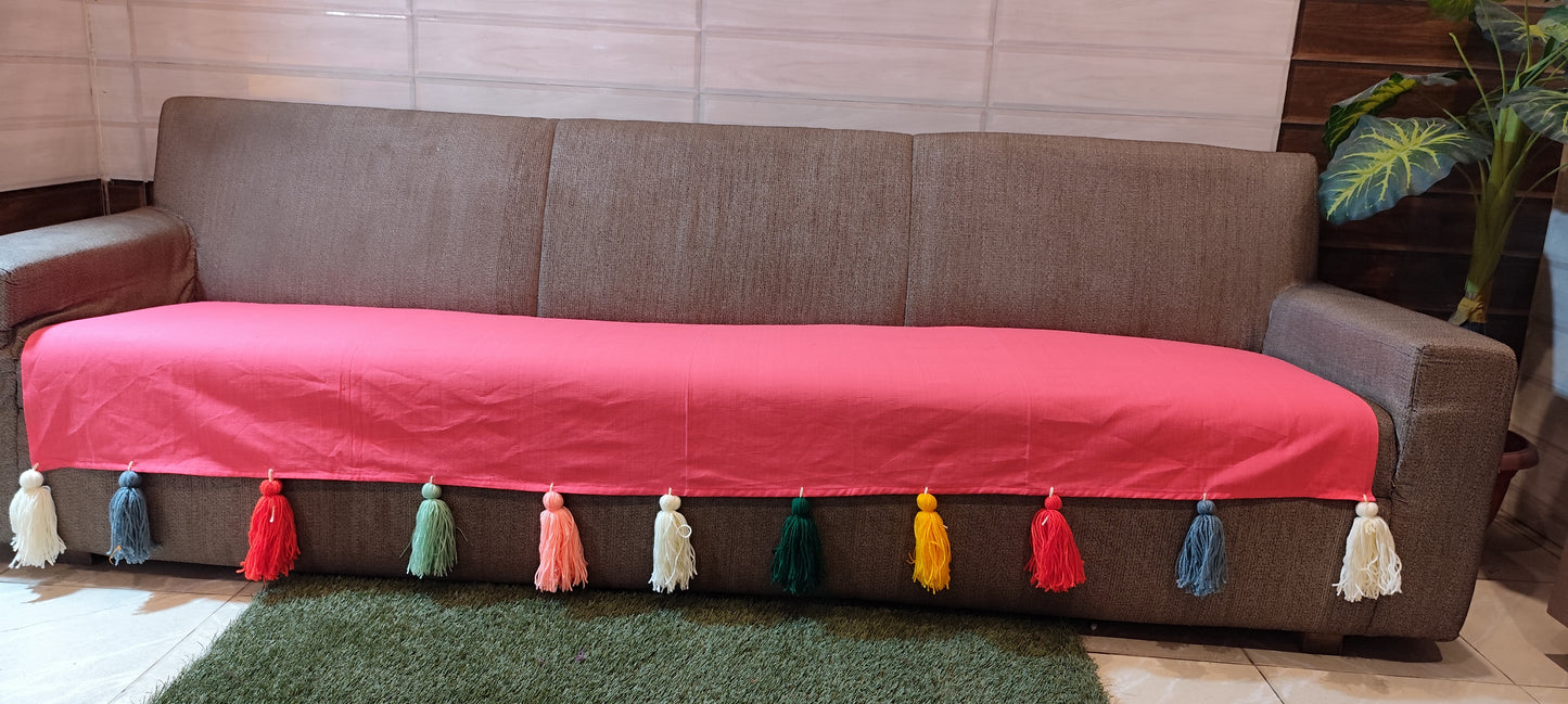 Carrot pink sofa cover with jumbo rainbow tassels