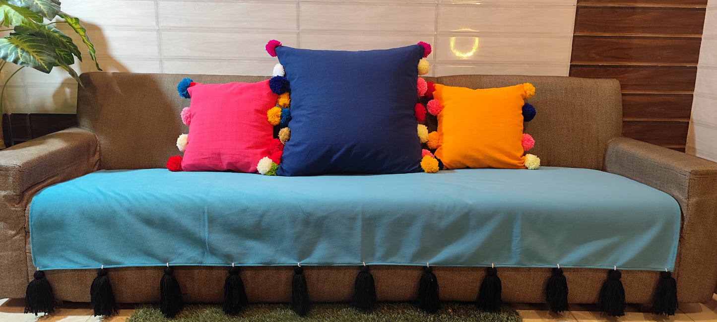 Antislip turquoise sofa cover with black jumbo tassels