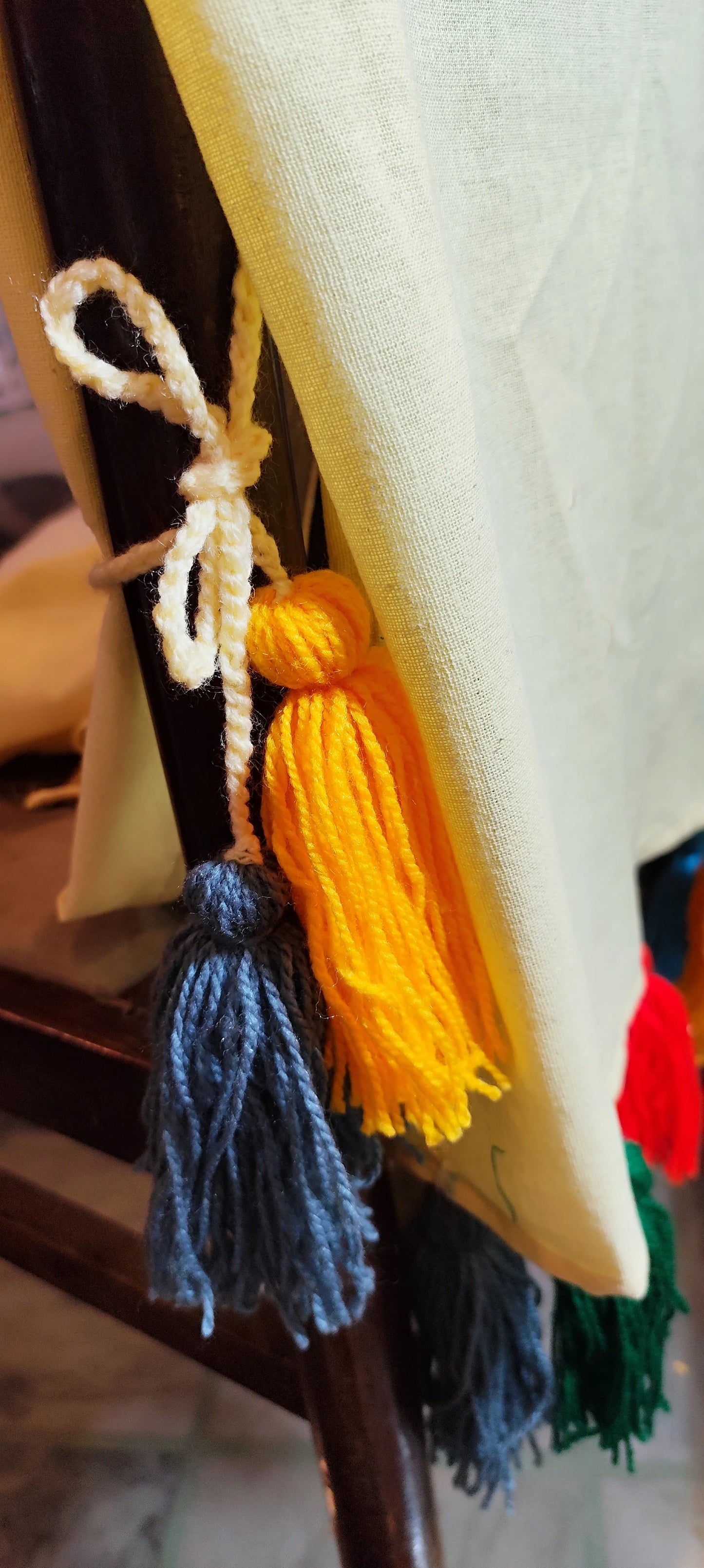 Lemon yellow chair cover with colourful tassel