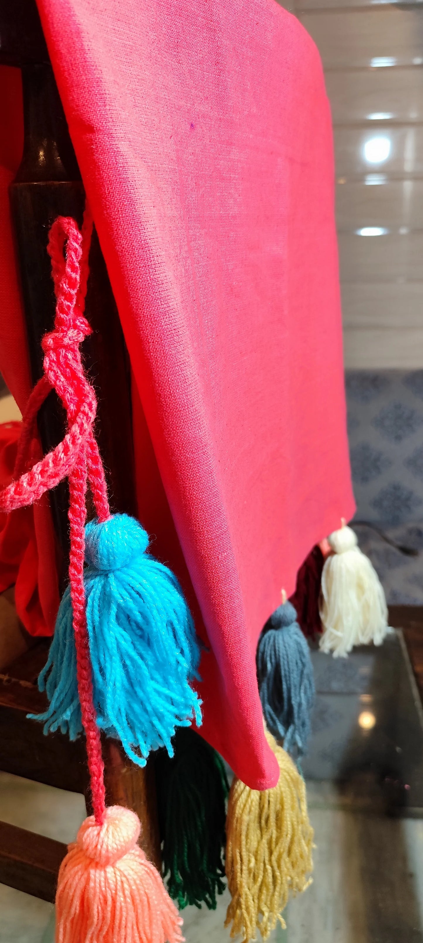 Pink chair cover with colourful tassel