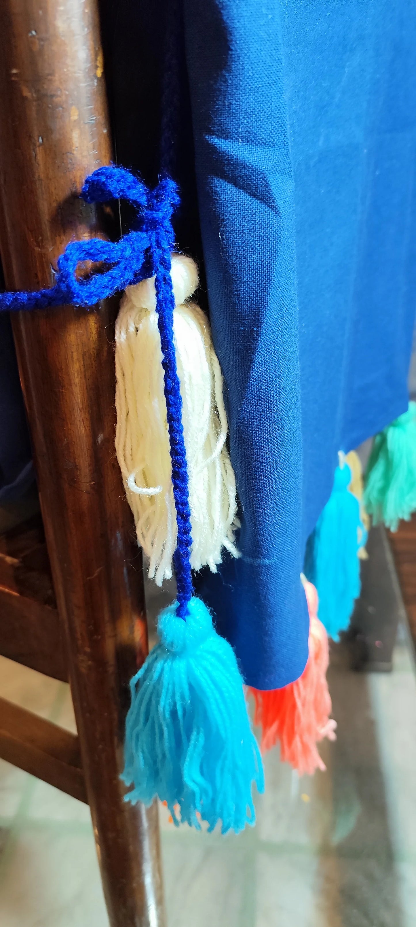 Emerald green chair cover with colourful tassel