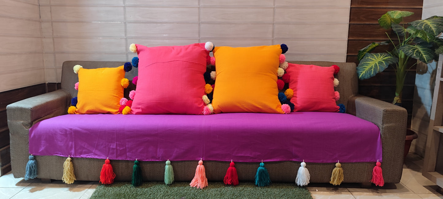 Purple sofa cover with jumbo rainbow tassel