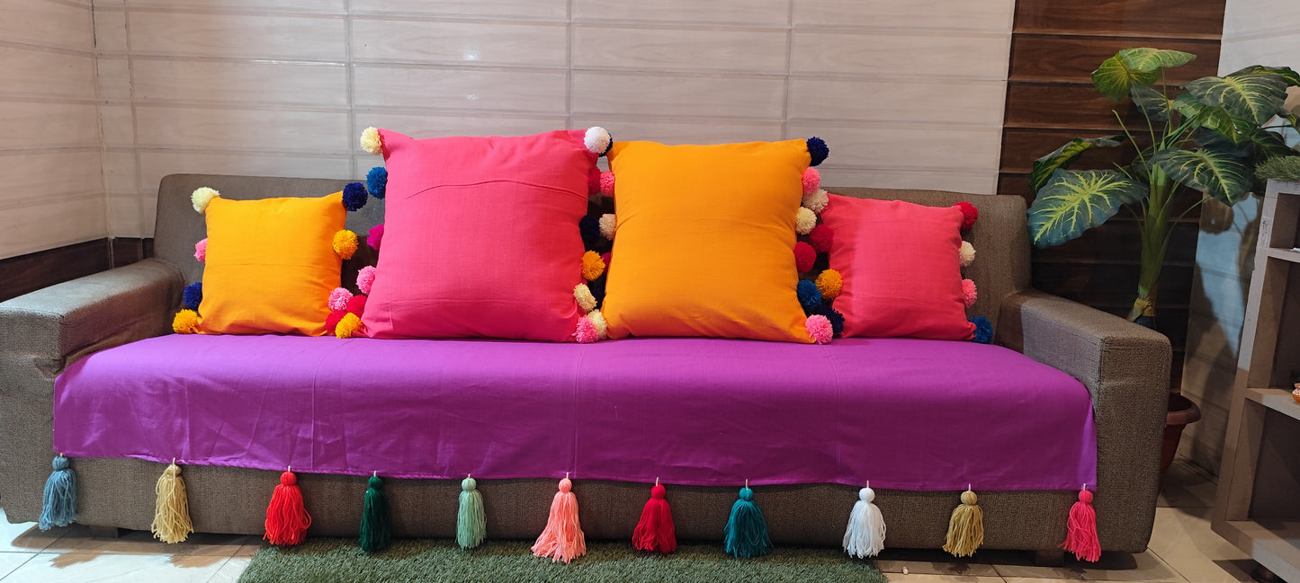 Purple sofa cover with jumbo rainbow tassel