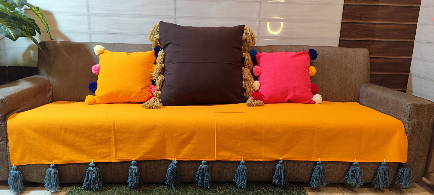 Mustard yellow sofa cover with grey jumbo tassels