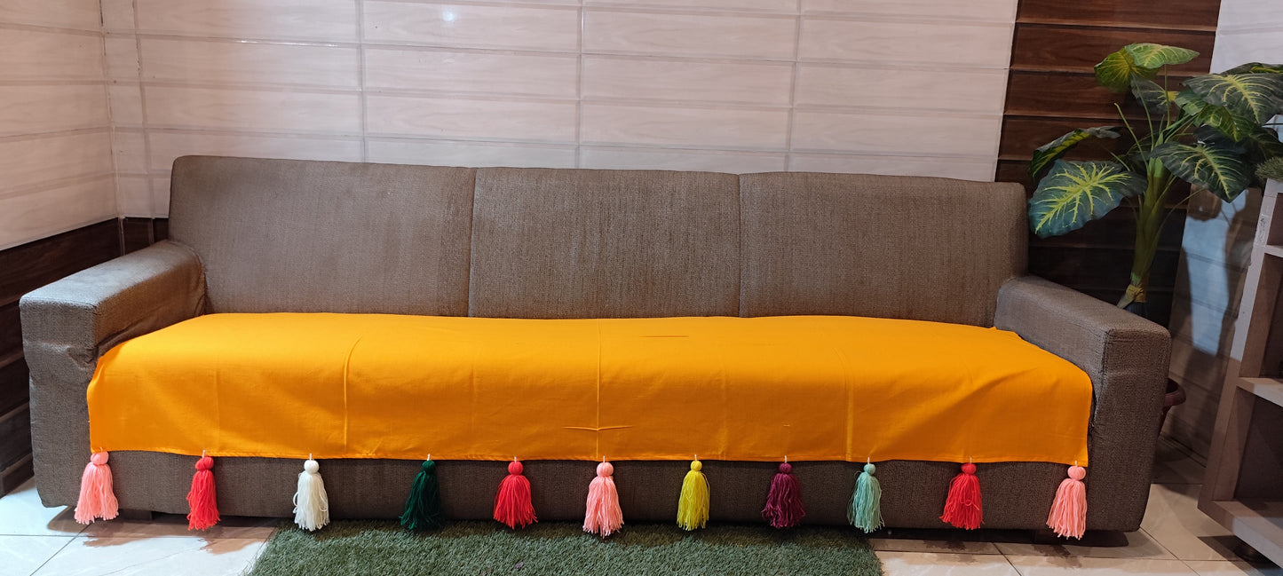 Mustard yellow sofa cover with jumbo rainbow tassel