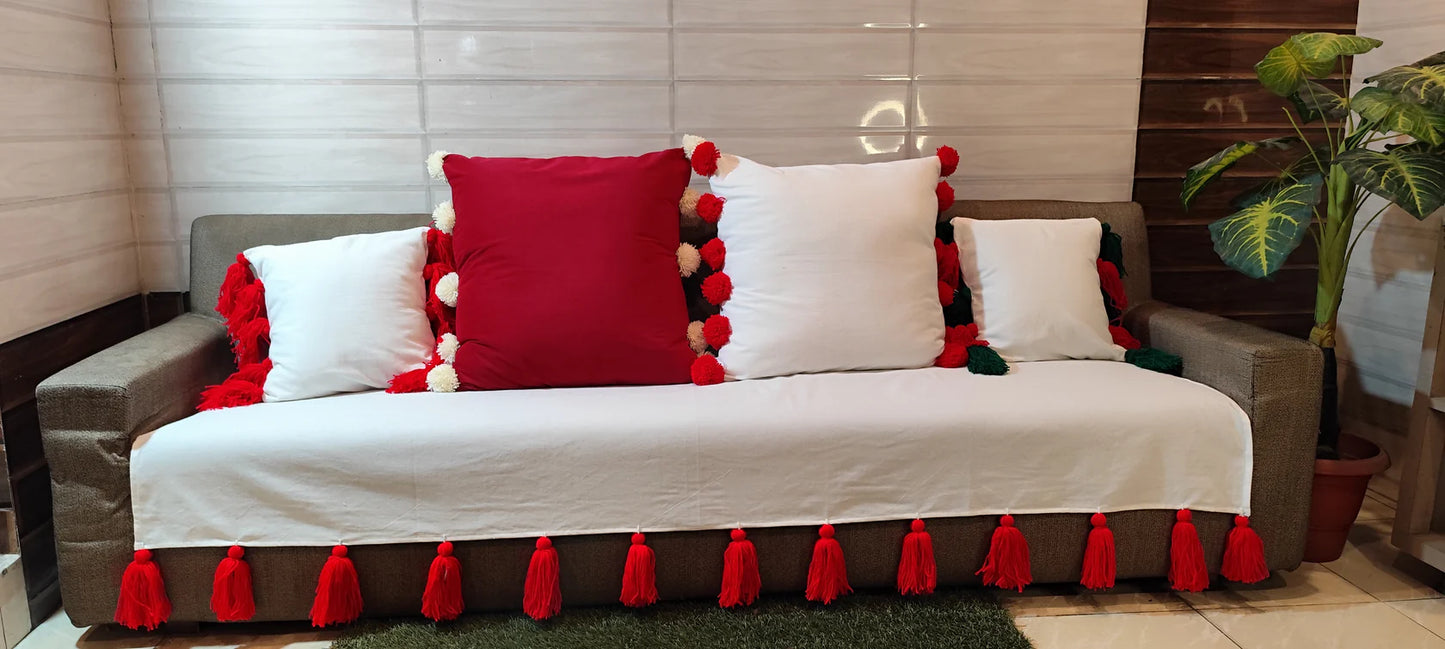 White cushion cover with red pompom balls