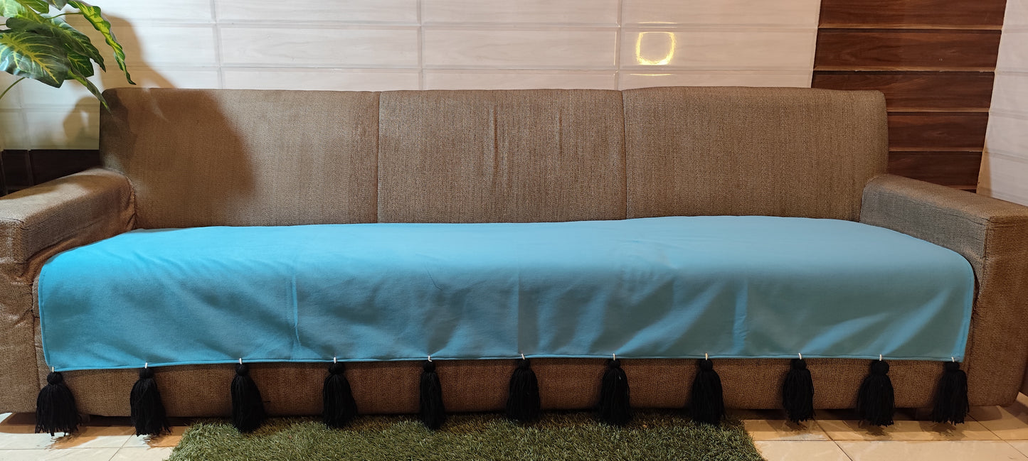 Antislip turquoise sofa cover with black jumbo tassels